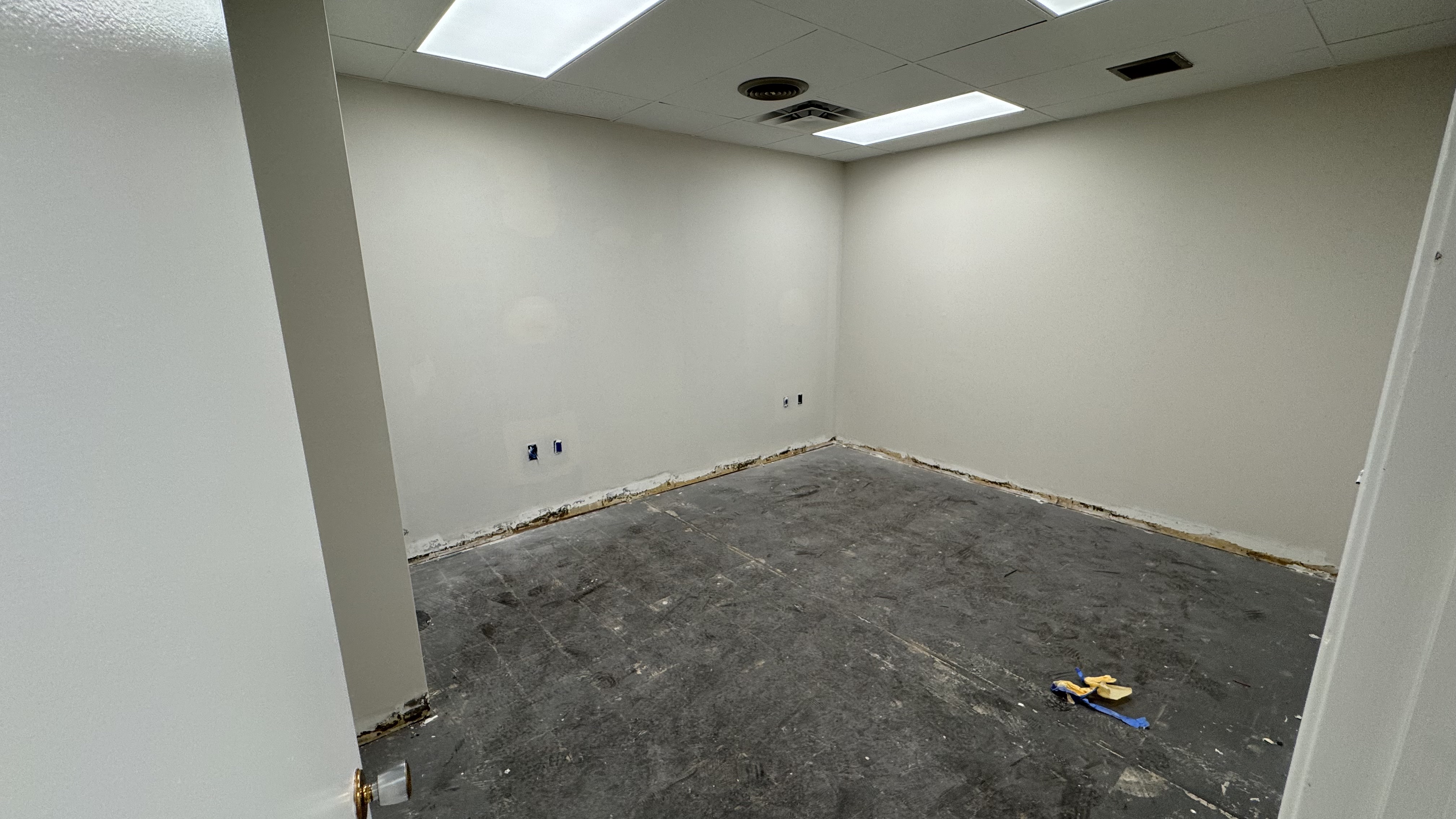 Commercial fit-out: baseboard heaters masked, walls repaired and rolled, room by room — YZ Painting & Finishing, Greater Vancouver
