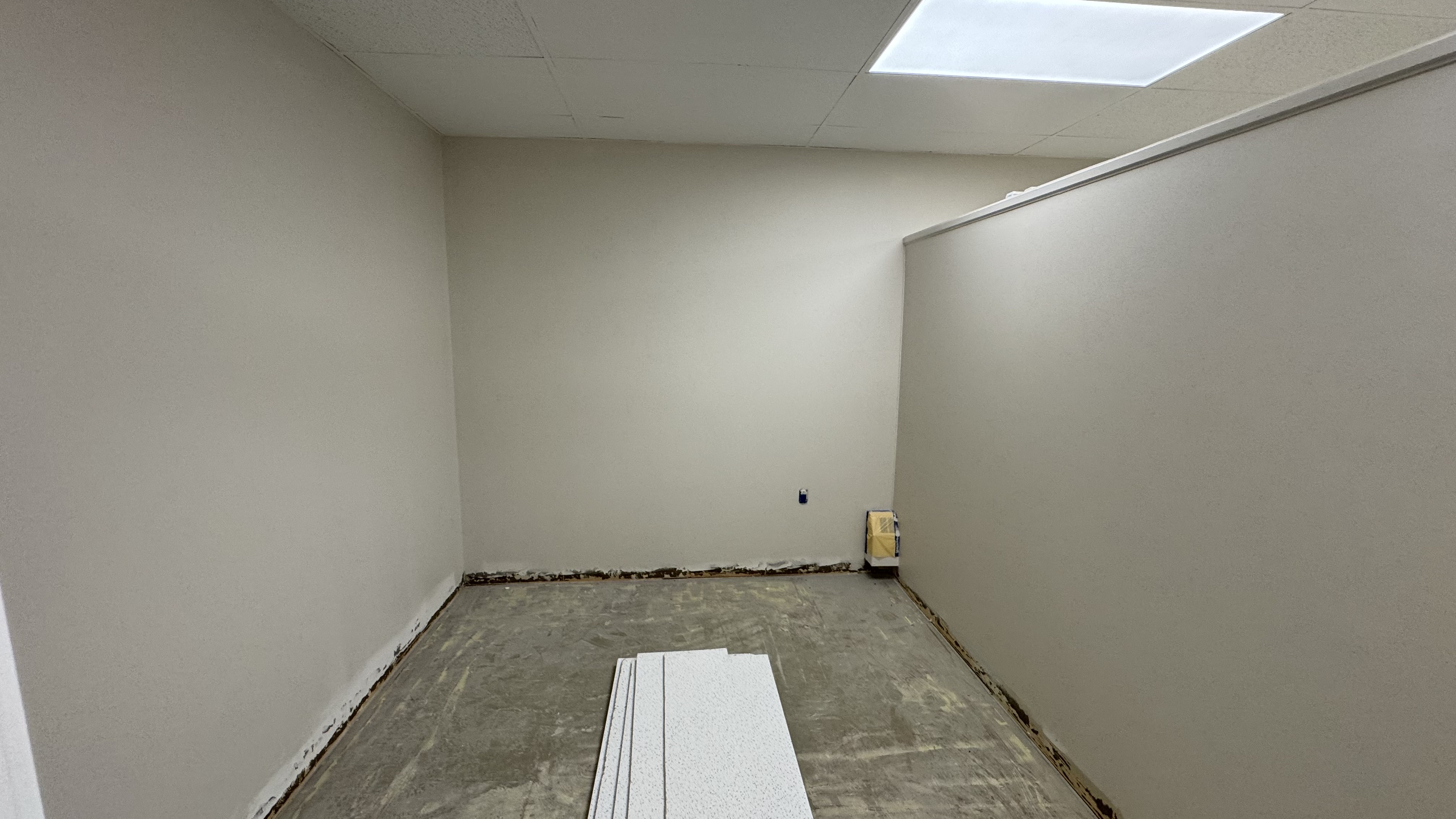 Commercial fit-out: baseboard heaters masked, walls repaired and rolled, room by room — YZ Painting & Finishing, Greater Vancouver