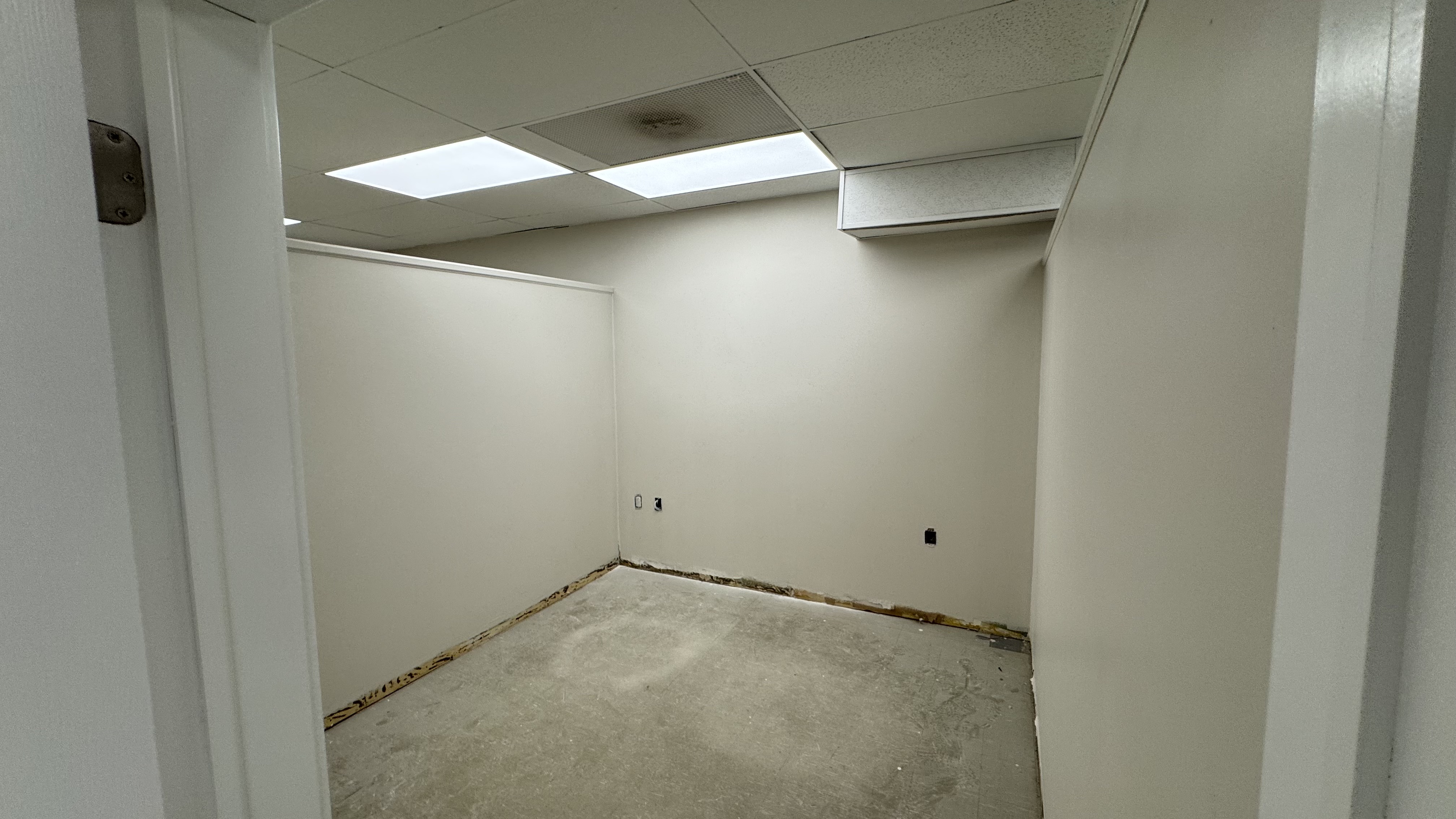 Commercial fit-out: baseboard heaters masked, walls repaired and rolled, room by room — YZ Painting & Finishing, Greater Vancouver