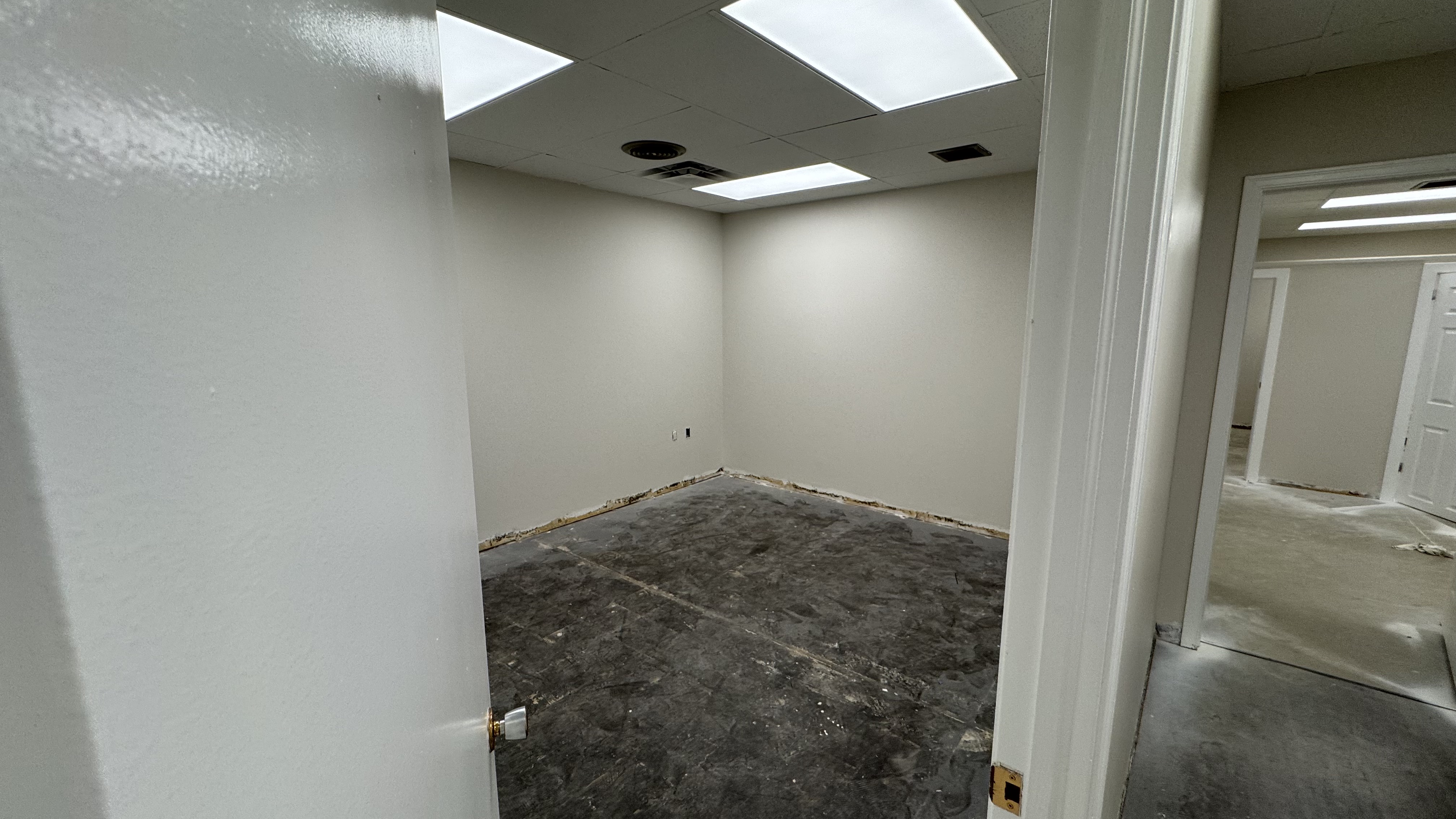 Commercial fit-out: baseboard heaters masked, walls repaired and rolled, room by room — YZ Painting & Finishing, Greater Vancouver