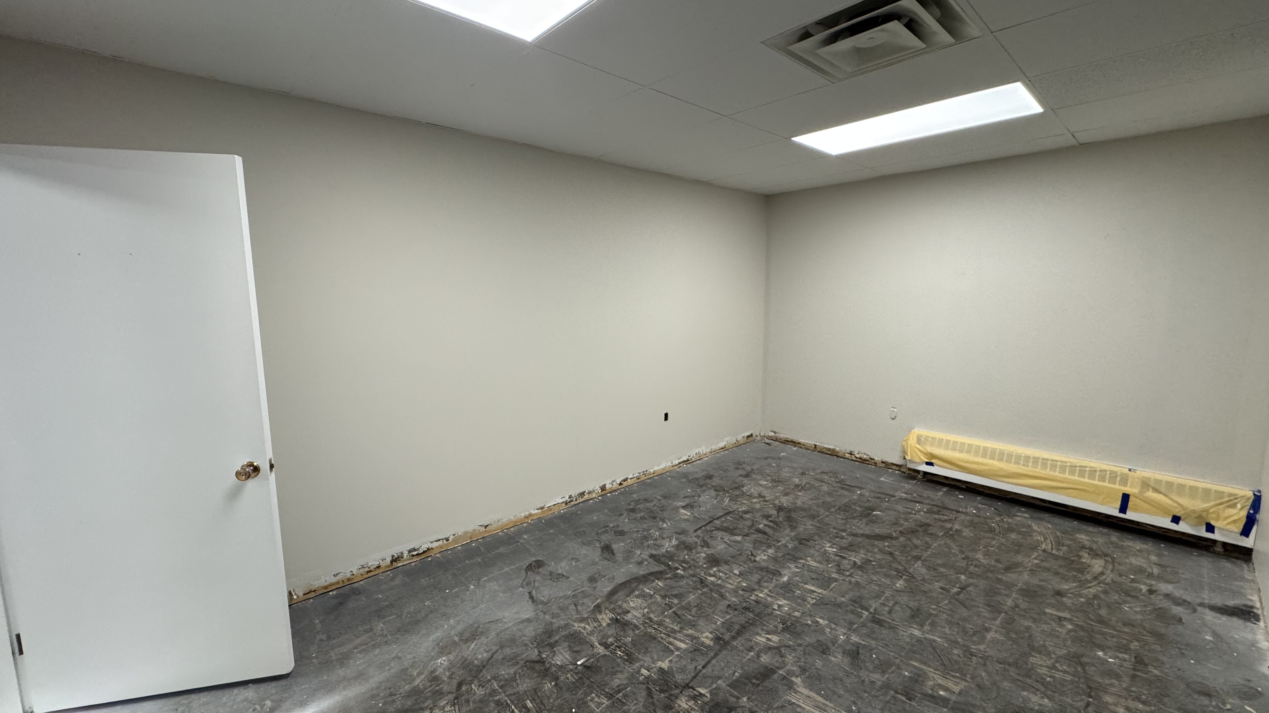 Commercial fit-out: baseboard heaters masked, walls repaired and rolled, room by room — YZ Painting & Finishing, Greater Vancouver