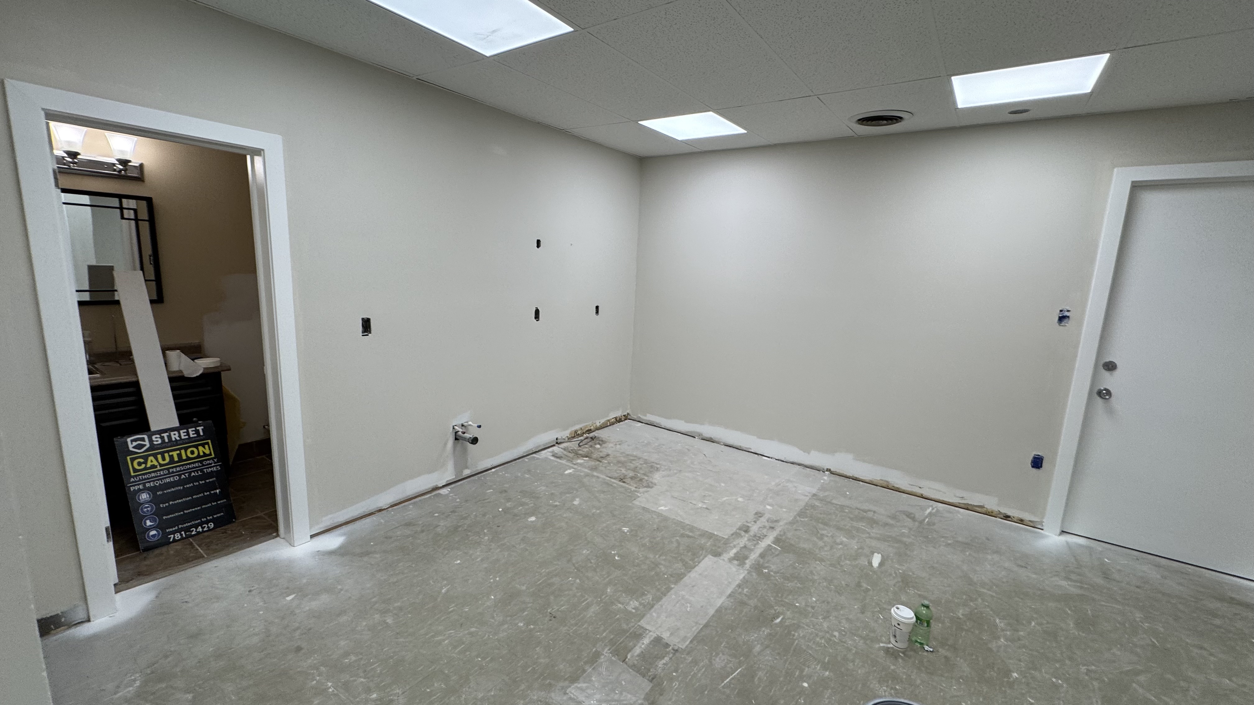 Commercial fit-out: baseboard heaters masked, walls repaired and rolled, room by room — YZ Painting & Finishing, Greater Vancouver