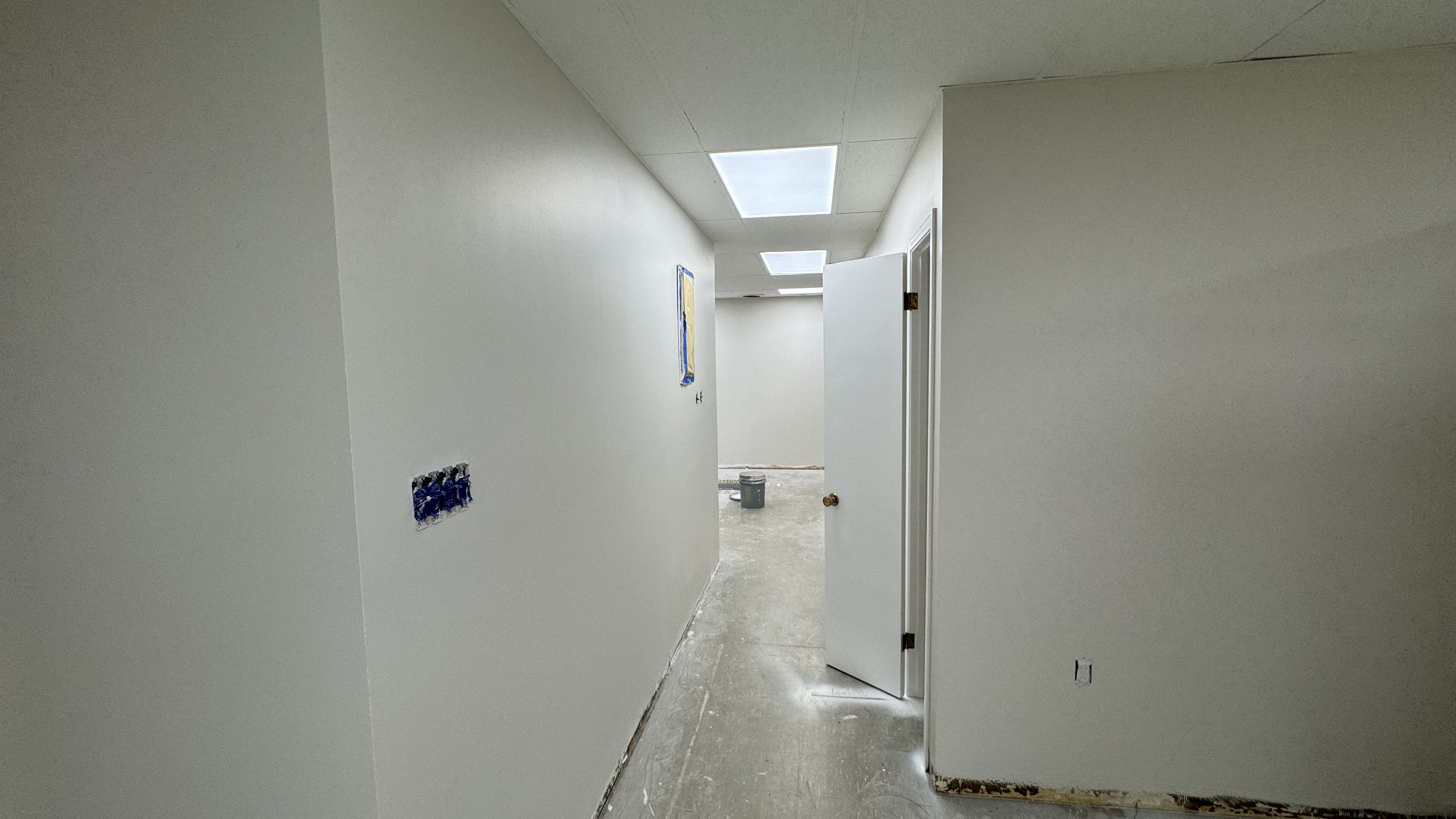 Commercial fit-out: baseboard heaters masked, walls repaired and rolled, room by room — YZ Painting & Finishing, Greater Vancouver