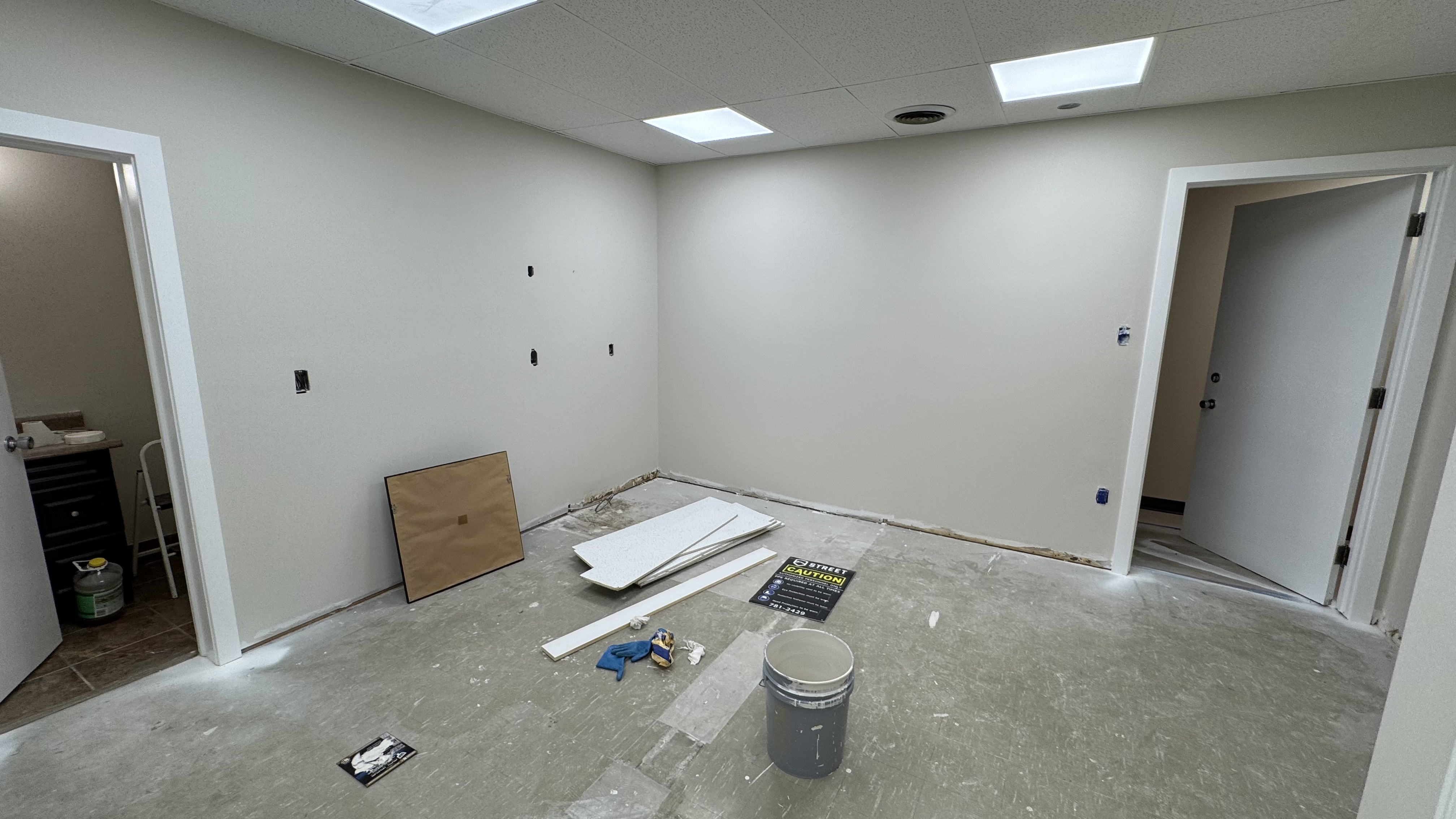 Commercial fit-out: baseboard heaters masked, walls repaired and rolled, room by room — YZ Painting & Finishing, Greater Vancouver