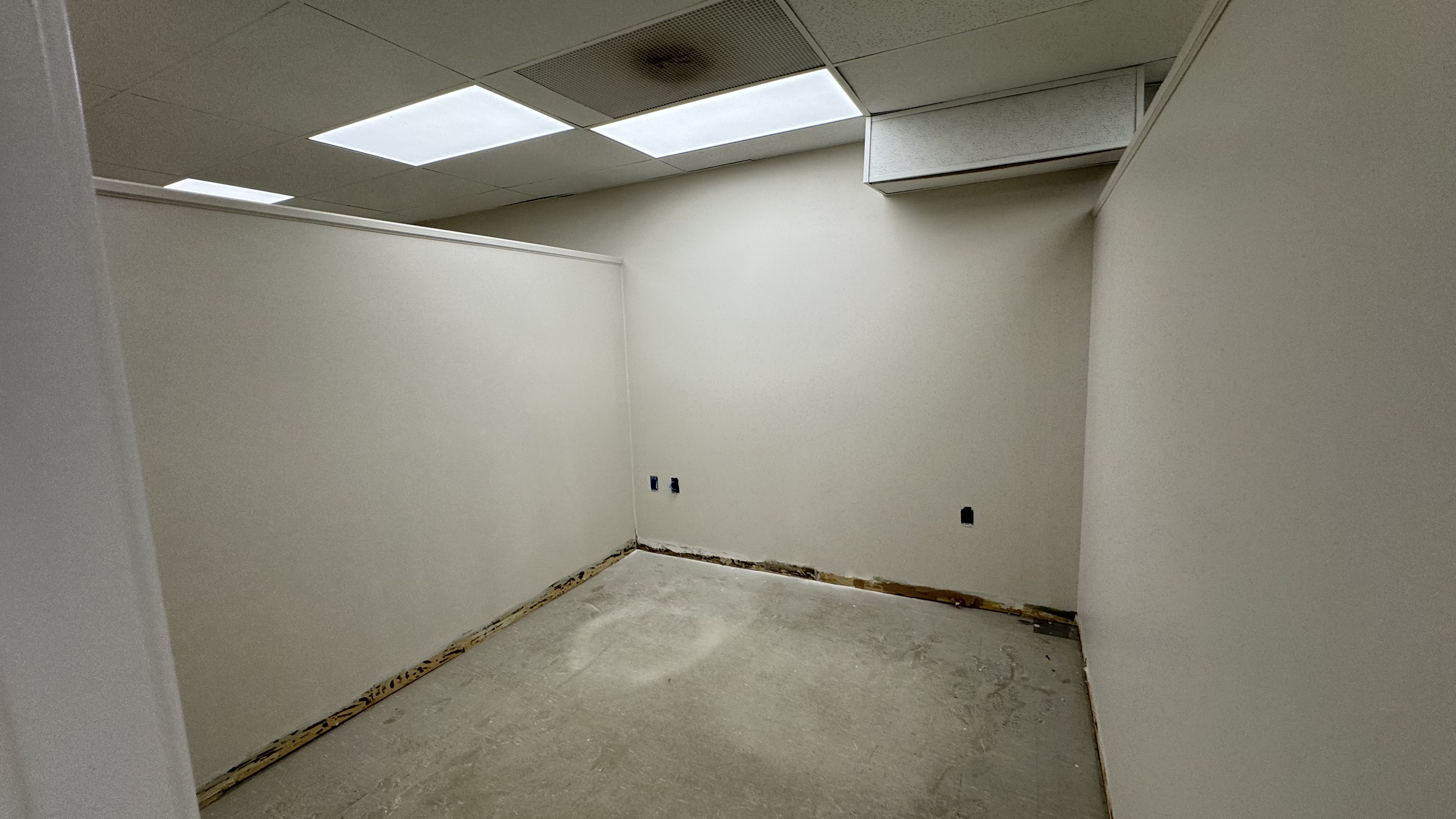 Commercial fit-out: baseboard heaters masked, walls repaired and rolled, room by room — YZ Painting & Finishing, Greater Vancouver