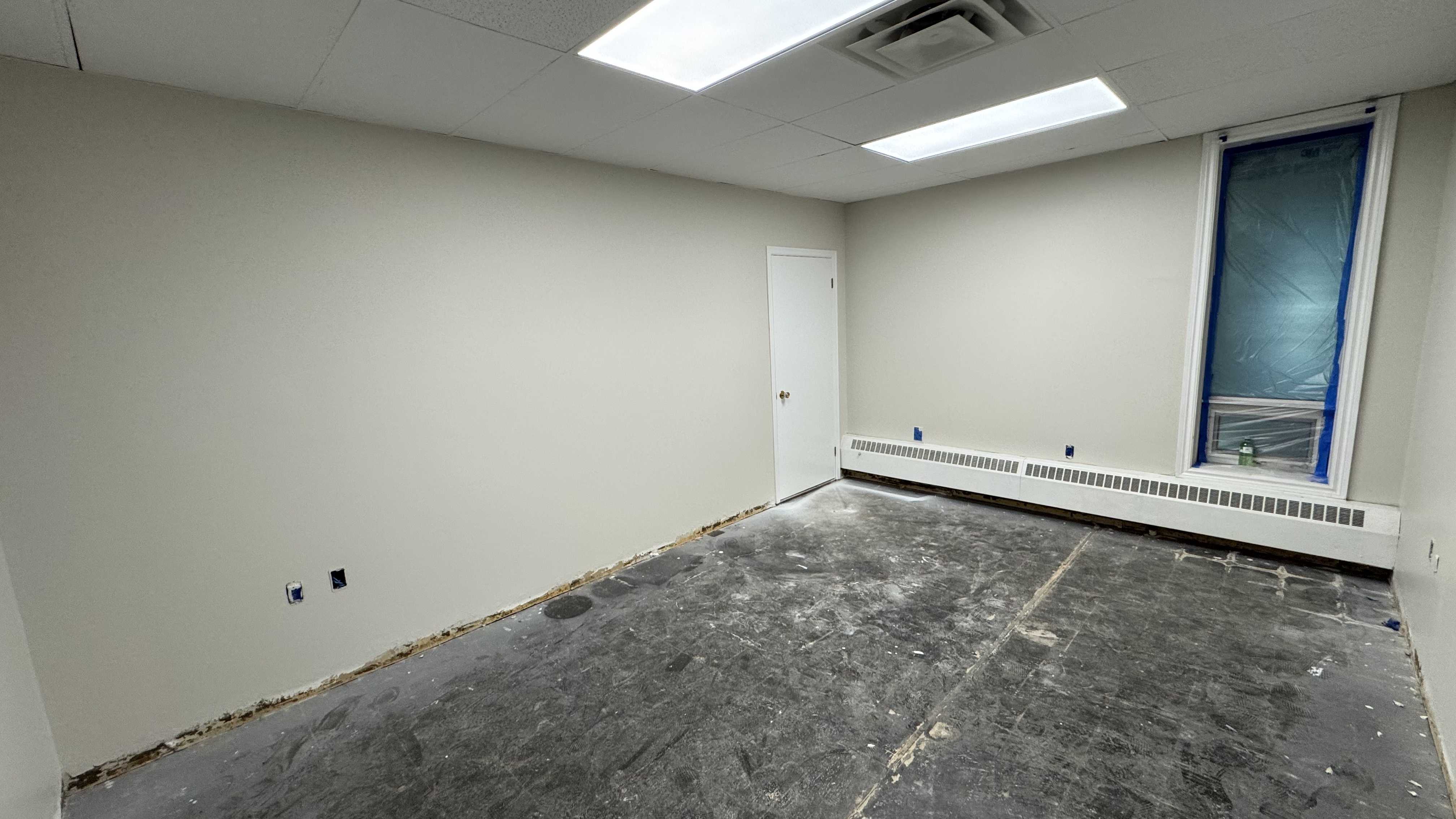 Commercial fit-out: baseboard heaters masked, walls repaired and rolled, room by room — YZ Painting & Finishing, Greater Vancouver