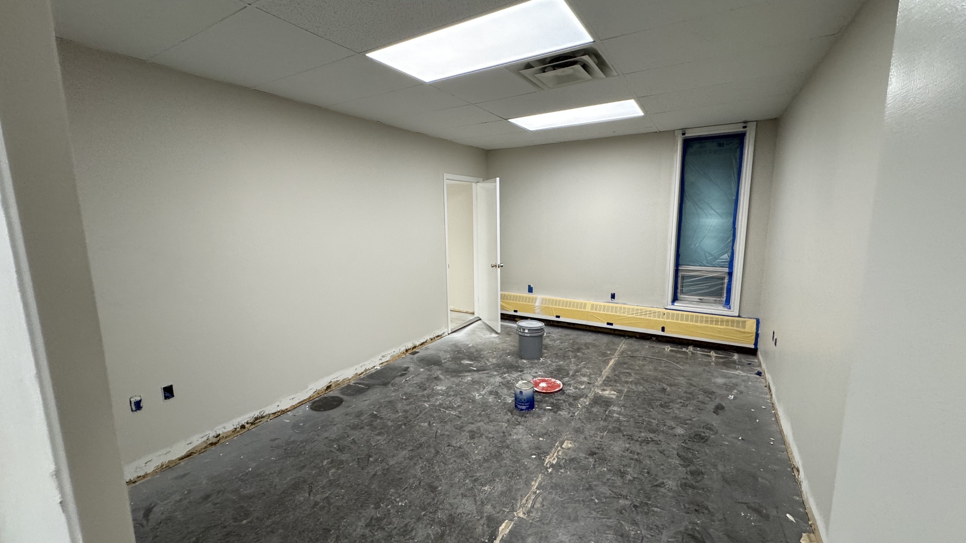 Commercial fit-out: baseboard heaters masked, walls repaired and rolled, room by room — YZ Painting & Finishing, Greater Vancouver